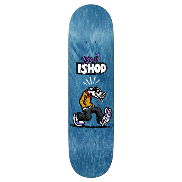 Real Ishod Wair 'Comix' pro model skateboard deck, 8.25 inches wide. Features a graphic of a personified dog walking below the Real brand script, sized 8.5" by 32.18"